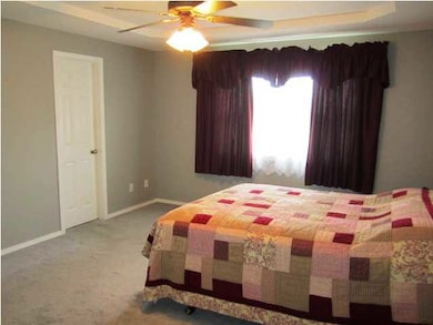 Large master bedroom offers coffererd celing and g