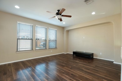 Unfurnished room with a ceiling fan, dark wood-st