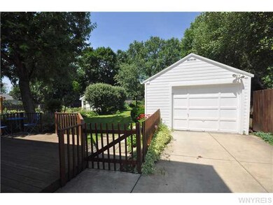 Garage. View of rear deck, concrete drive and over