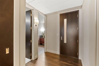 Front door with view to full bathroom and 2nd bedr