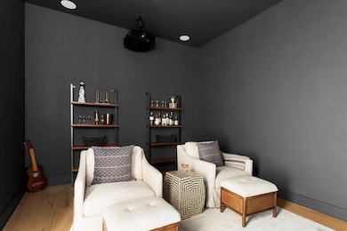 Living area with wood finished floors and baseboa
