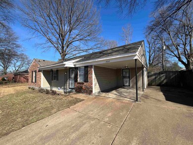 View of front of property featuring a carport, con