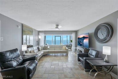 Living area featuring stone tile flooring, ceiling