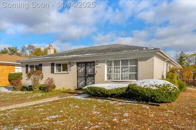 View of front of home with a chimney, brick siding, and a front lawn