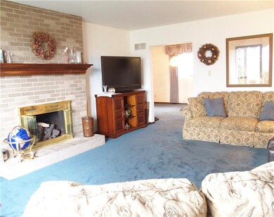 The living room has tons of natural light and a br