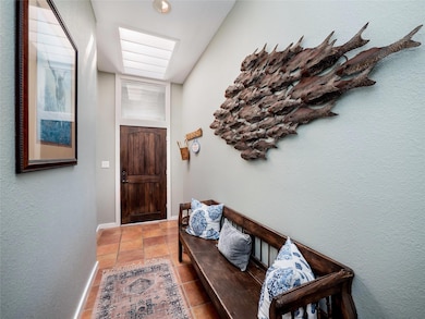 Doorway with a textured wall and tile patterned f