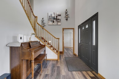 Spacious foyer with soaring two-story vaulted ceiling.