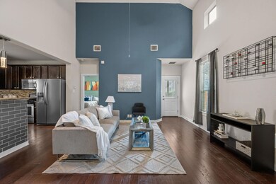Living room featuring a towering ceiling, healthy