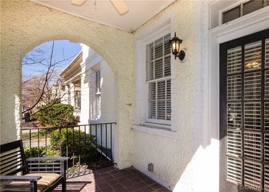 The charming patio has tile flooring, arches, bead-board ceiling and a ceiling fan.