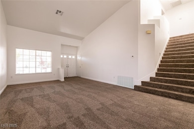 Unfurnished living room with visible vents, carpet