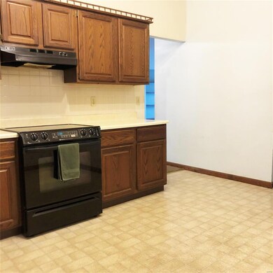 Kitchen has newer drop-in electric range.  Vaulted