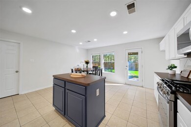 Another view of island kitchen with views of the private backyard !