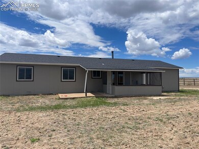 Rear view of property with a deck and enclosed pat