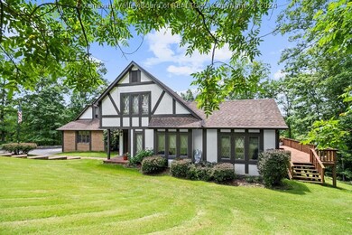 The home sits in a large clearing. The land is ful