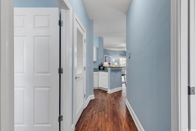 Hall with dark hardwood / wood-style flooring