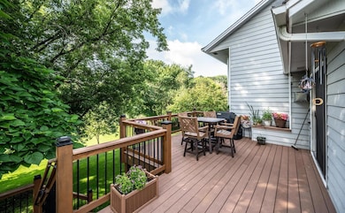 The maintenance-free deck is surrounded by trees and a gorgeous view of the backyard