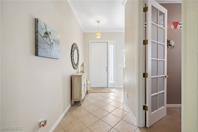 Foyer entrance with light tile patterned floors an
