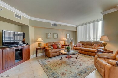 Living area with crown molding, light tile pattern
