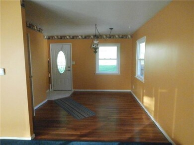 Dining Room with gleaming hardwood floors and door