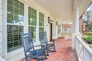 A COVERED FRONT PORCH GRACIOUSLY WELCOMES YOUR GUESTS INSIDE.