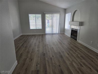 Unfurnished living room featuring dark wood finish