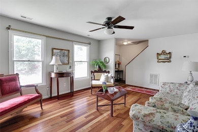 Living room featuring wood finished floors and a ceiling fan