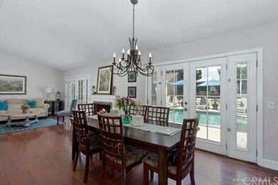 The dining room has a beautiful chandelier and add