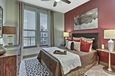 Carpeted bedroom featuring ceiling fan