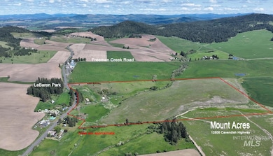 Overview of rural landscape featuring property boundaries highlighted and mountains