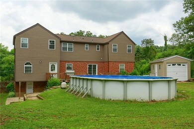 Back of house, deck, pool and shed