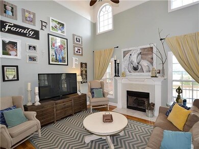 Living room with wood burning fireplace for the chilly nights - opens to covered porch and pool area