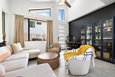 Living room featuring ceiling fan, a towering cei