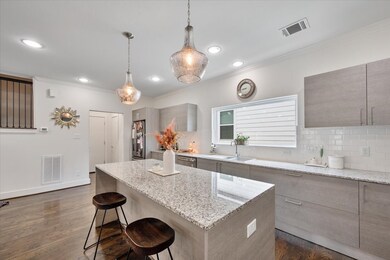 This kitchen is perfect for entertaining, featuring a spacious island, ample counter space, and sleek granite countertops.
