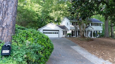 View of front of home with asphalt driveway, a garage, and brick siding