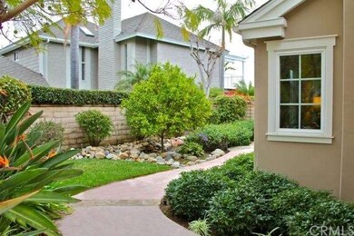Inviting front walk leads past a flourishing orang