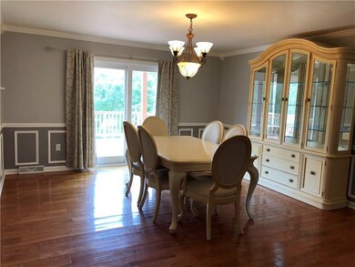 Dining room overlooks deck and rear yard with glea