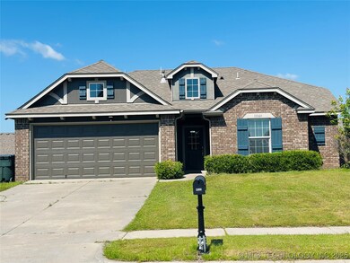 View of front of home with brick siding, driveway,