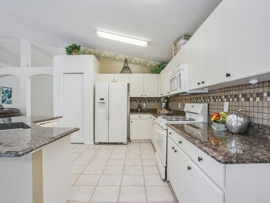 Gourmet kitchen features plenty of granite counter