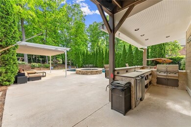 View of patio featuring area for grilling, a pool 