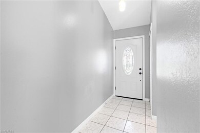Doorway featuring light tile patterned flooring