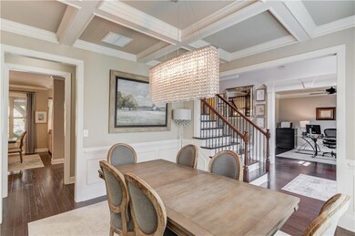 Dining area featuring dark wood-style flooring, be