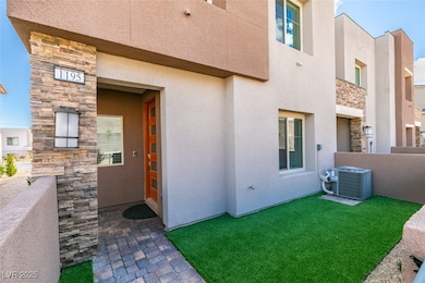 View of exterior entry featuring stone siding, stu