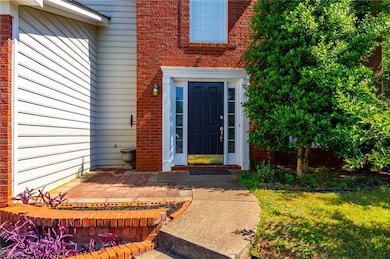 View of exterior entry featuring brick siding