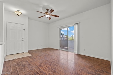 LIVING room with baseboards, ceiling fan, and wood