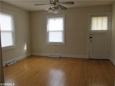 Living Room - Nice wood floors and ceiling fan.