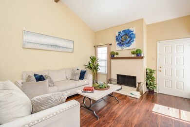 Bright living room with fireplace, high ceilings a