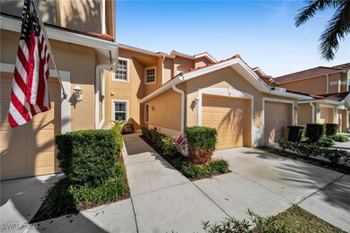 View of front facade featuring stucco siding, a ga