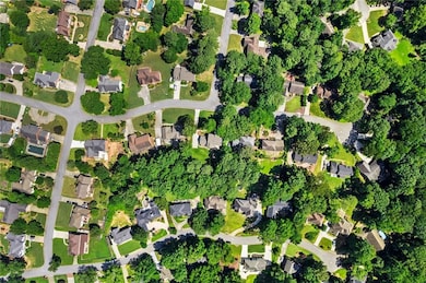 Aerial view of property's location featuring nearby suburban area