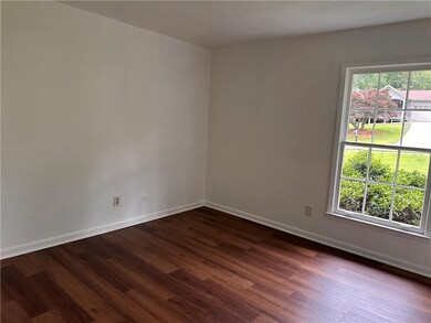 Unfurnished room with dark wood-style floors