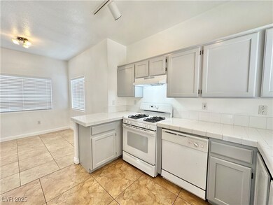 Kitchen featuring white appliances, a peninsula, u